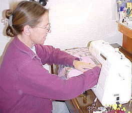 Cindy sewing the quilt pieces into blocks